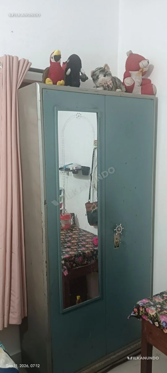 Green Metal Almirah with Mirror and Toys on Top